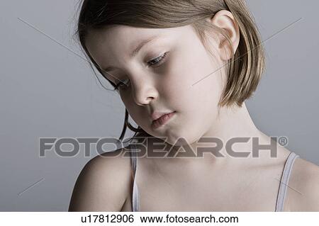 Stock Photograph - Studio portrait of sad girl (6-7). Fotosearch