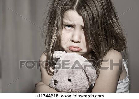Studio portrait of sad girl (6-7) with pink teddy bear View Large Photo Image Stock Photo - Studio portrait of sad girl (6-7) with pink teddy bear. Fotosearch