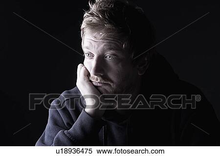 Stock Photography - Studio portrait of sad man. Fotosearch