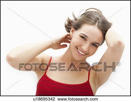 Stock Image - Studio portrait of smiling young woman. Fotosearch