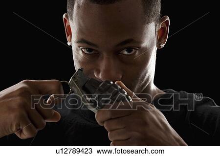 Studio portrait of young man holding grenade View Large Photo Image Stock Image - Studio portrait of young man holding grenade. Fotosearch