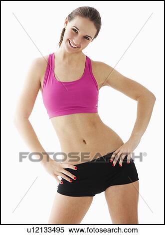 Stock Photography - Studio portrait of young woman exercising. Fotosearch