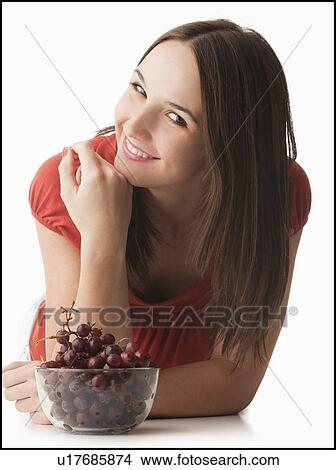 Studio portrait of young woman with grapes View Large Photo Image Picture - Studio portrait of young woman with grapes. Fotosearch