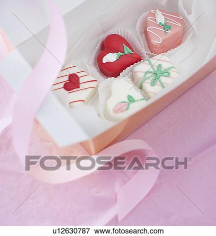 Stock Photo - Studio shot of box of heart-shaped candies. Fotosearch