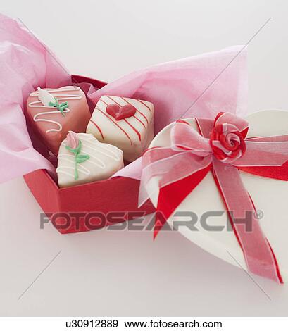 Stock Photo - Studio shot of box of heart-shaped candies. Fotosearch
