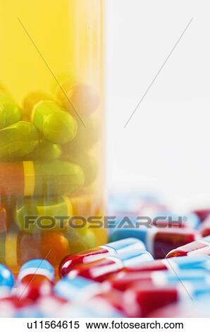 Studio shot of capsules and pill bottle View Large Photo Image Stock Photography - Studio shot of capsules and pill bottle. Fotosearch