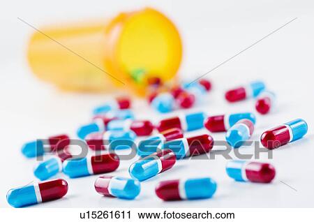 Studio shot of capsules spilling from bottle View Large Photo Image Stock Image - Studio shot of capsules spilling from bottle. Fotosearch