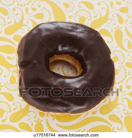 Studio shot of chocolate donut on floral background View Large Photo Image Picture - Studio shot of chocolate donut on floral background. Fotosearch