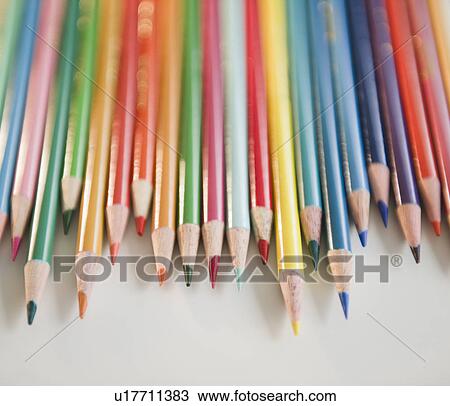 Stock Image - Studio shot of colored pencils in row. Fotosearch
