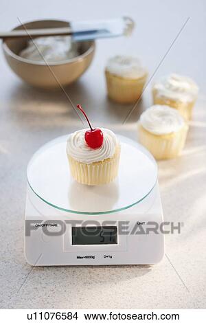 Studio shot of cupcake on weight scale View Large Photo Image Picture - Studio shot of cupcake on weight scale. Fotosearch