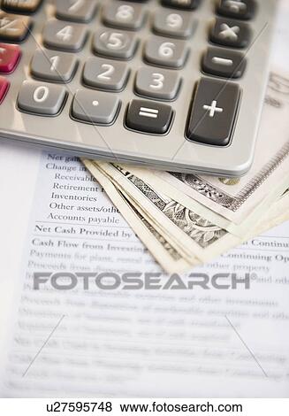 Stock Photo - Studio shot of documentMoney and calculator. Fotosearch