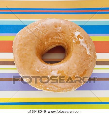 Studio shot of donut on striped background View Large Photo Image Stock Photo - Studio shot of donut on striped background. Fotosearch