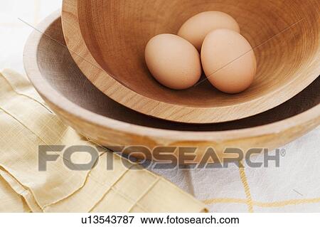 Studio shot of eggs in wooden bowl View Large Photo Image Stock Photo - Studio shot of eggs in wooden bowl. Fotosearch