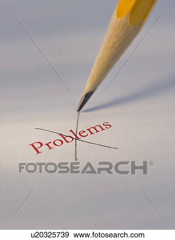 Stock Photo - Studio shot of pencil crossing out the word problems from piece of paper. Fotosearch