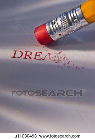 Stock Image - Studio shot of pencil erasing the word dream from piece of paper. Fotosearch