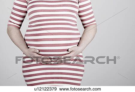 Studio shot of pregnant woman View Large Photo Image Stock Photo - Studio shot of pregnant woman. Fotosearch