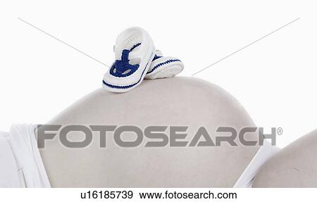 Stock Photo - Studio shot of pregnant woman. Fotosearch