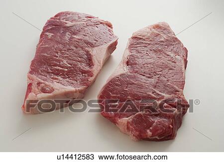Stock Image - Studio shot of raw steak. Fotosearch