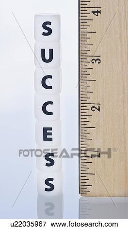 Stock Photo - Studio shot of ruler and dice spelling out success. Fotosearch