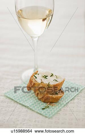 Picture - Studio shot of small sandwich and glass of white wine. Fotosearch