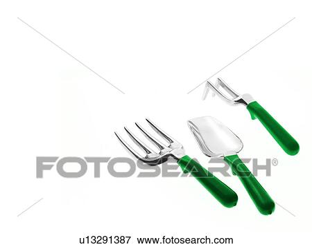 Stock Photo - Studio shot of spade and gardening forks. Fotosearch