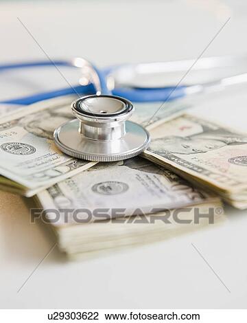 Studio shot of stethoscope on banknotes View Large Photo Image Stock Image - Studio shot of stethoscope on banknotes. Fotosearch