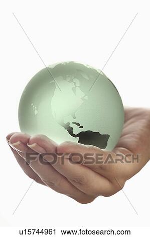 Studio shot of woman holding glass globe model View Large Photo Image Stock Image - Studio shot of woman holding glass globe model. Fotosearch