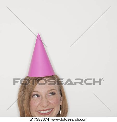 Studio shot of woman wearing pink party hat View Large Photo Image Picture - Studio shot of woman wearing pink party hat. Fotosearch