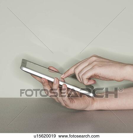 Studio shot of woman with digital tablet View Large Photo Image Stock Photo - Studio shot of woman with digital tablet. Fotosearch