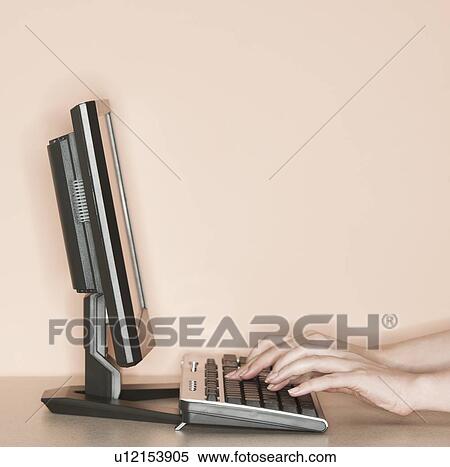 Studio shot of woman working on computer View Large Photo Image Stock Photography - Studio shot of woman working on computer. Fotosearch