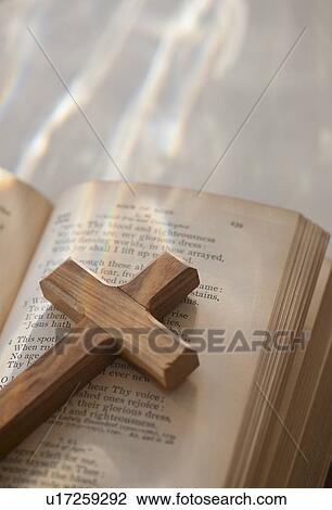 Stock Image - Studio shot of wooden cross and bible. Fotosearch
