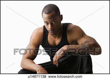 Studio shot of young man in sports clothing View Large Photo Image Stock Photo - Studio shot of young man in sports clothing. Fotosearch