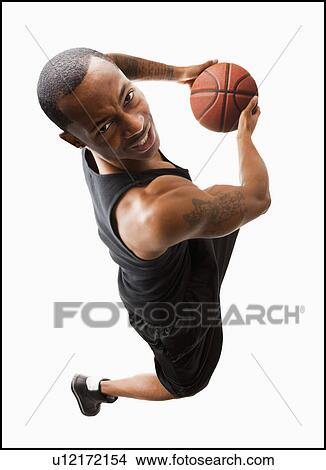Studio shot of young man playing basketball View Large Photo Image Picture - Studio shot of young man playing basketball. Fotosearch