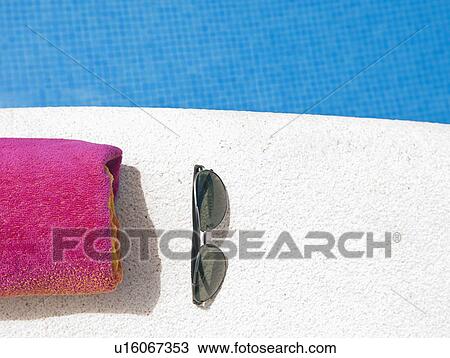 Stock Image - Sunglasses and towel. Fotosearch