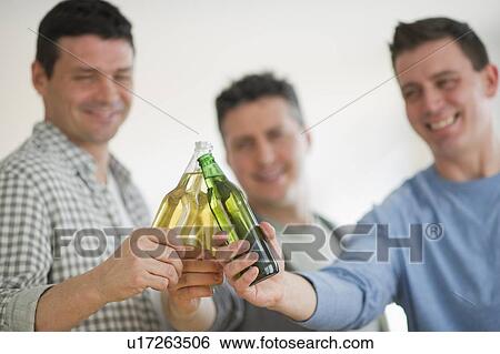Three men toasting with beer View Large Photo Image Stock Photograph - Three men toasting with beer. Fotosearch