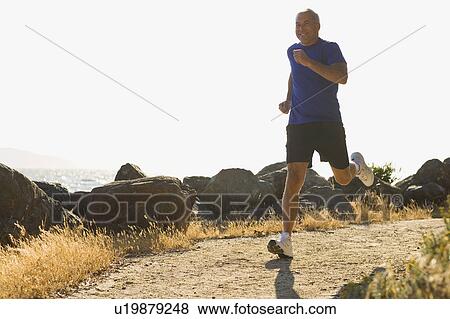 Stock Photo - USA, California, Berkeley, Senior man jogging. Fotosearch