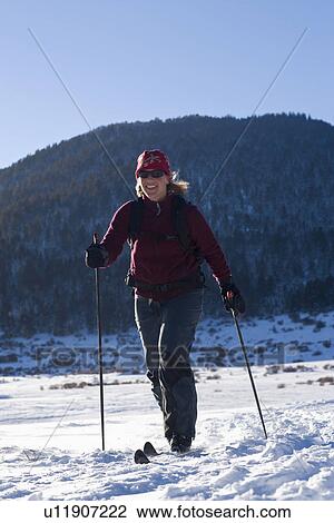 Stock Image - USA, California, Lake Tahoe, Mid adult woman skiing. Fotosearch