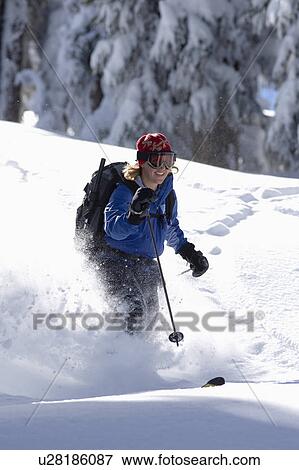 Stock Photo - USA, California, Lake Tahoe, Mid adult woman skiing. Fotosearch