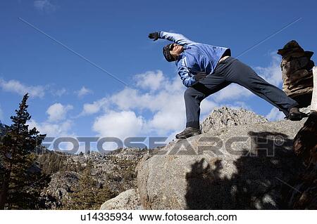 USA, California, Lake Tahoe, Woman exercising on rock View Large Photo Image Picture - USA, California, Lake Tahoe, Woman exercising on rock. Fotosearch