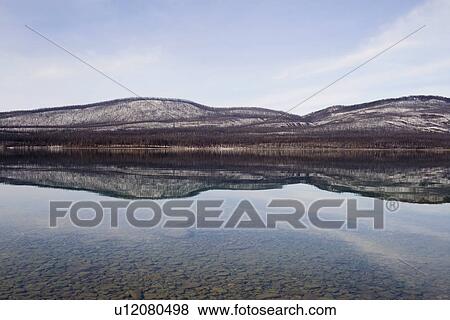 Stock Photo - USA, Colorado, Hills reflected in lake. Fotosearch