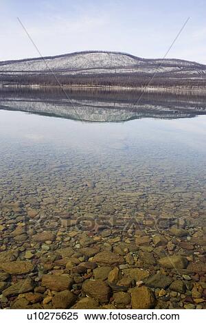 Stock Photography - USA, Colorado, Hills reflected in lake. Fotosearch