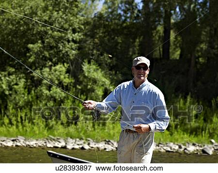 Stock Photo - USA, Colorado, Man fly-fishing. Fotosearch