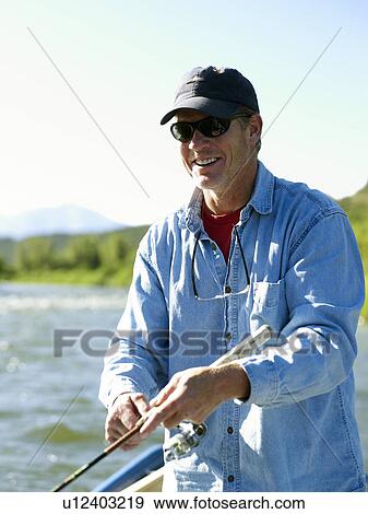 USA, Colorado, Mature man fly-fishing View Large Photo Image Stock Photo - USA, Colorado, Mature man fly-fishing . Fotosearch