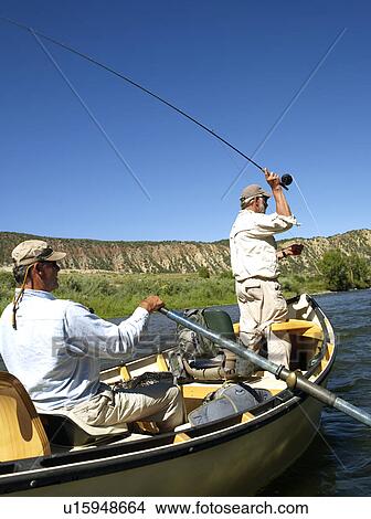 Picture - USA, Colorado, Pair of men fly-fishing on mountain river. Fotosearch