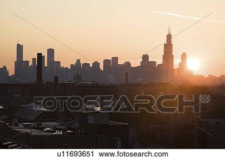 Stock Image - USA, Illinois, Chicago skyline at sunrise. Fotosearch