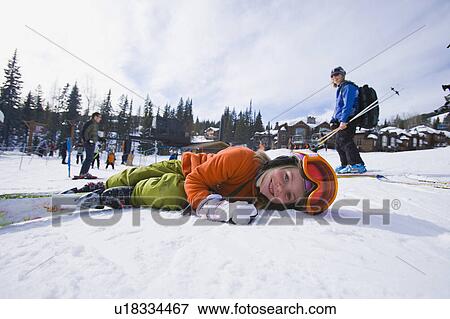 Stock Photo - USA, Montana, Whitefish, Girl (8-9) skiing with her mother. Fotosearch