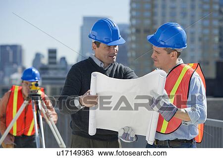 USA, New Jersey, Jersey City, construction workers reading blueprint View Large Photo Image Stock Image - USA, New Jersey, Jersey City, construction workers reading blueprint. Fotosearch