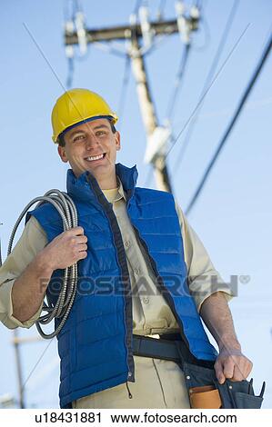Stock Image - USA, New Jersey, Jersey City, electrician at work. Fotosearch