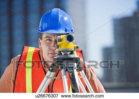 USA, New Jersey, Jersey City, construction worker in hard hat using theodolite View Large Photo Image Stock Photo - USA, New Jersey, Jersey City, construction worker in hard hat using theodolite. Fotosearch