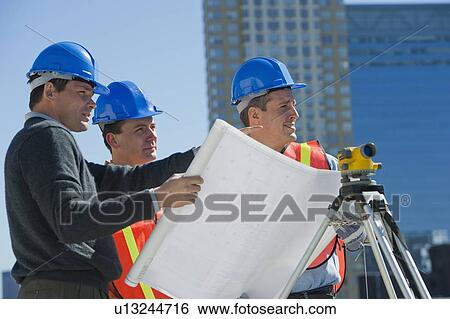 USA, New Jersey, Jersey City, construction workers reading blueprint View Large Photo Image Stock Photograph - USA, New Jersey, Jersey City, construction workers reading blueprint. Fotosearch